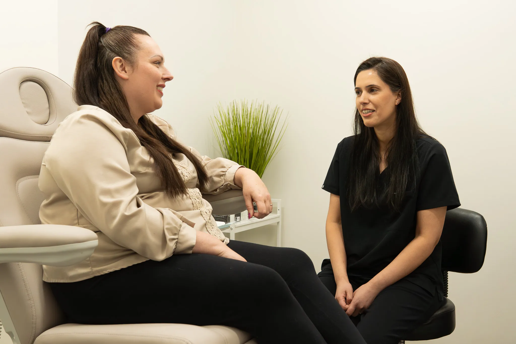 Dr. Sarai in conversation with a patient in a consultation room at Serene Rejuvenation.